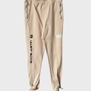 Shane Justin beige Jogger Pants with zipper pockets and ankle drawstrings.